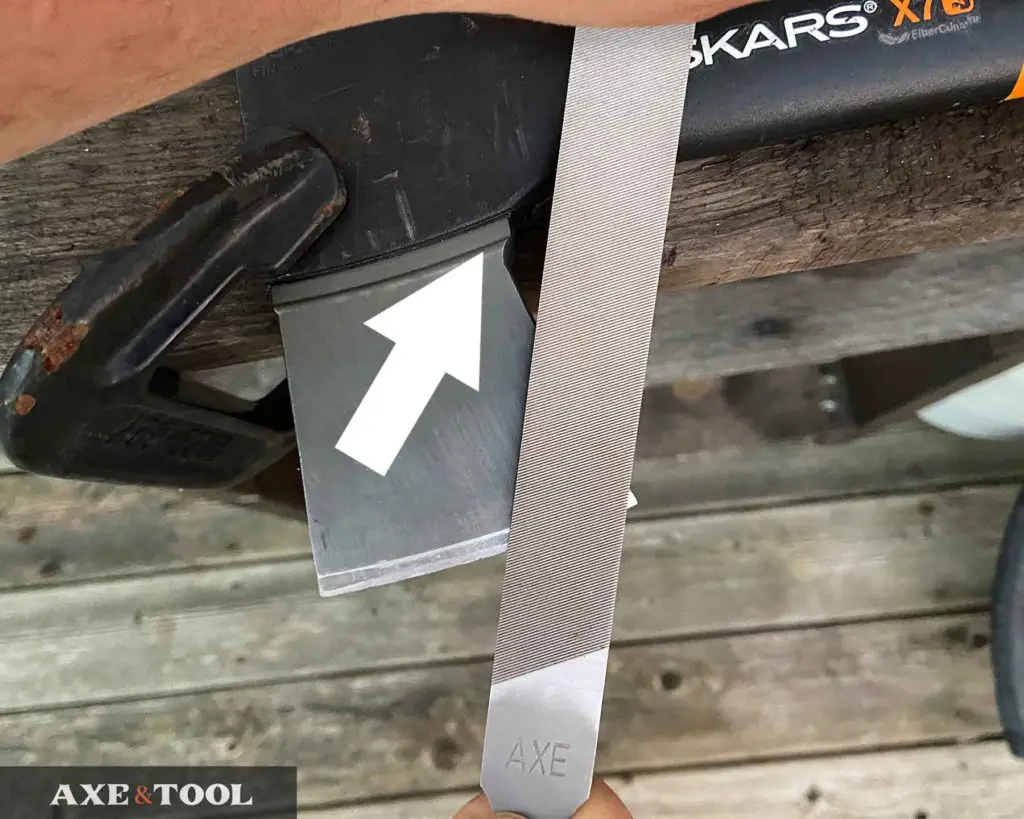 filing the blade of a fiskars axe with an axe file
