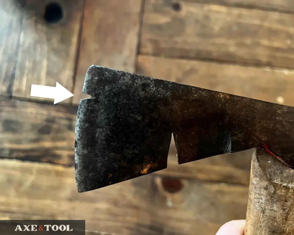 axe head with nail pulling notches, one in blade