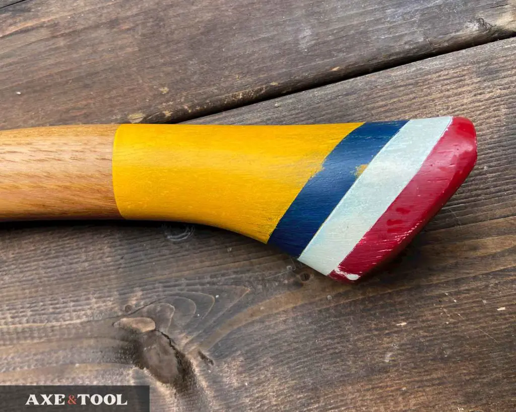 A distressed and vintage looking painted axe handle