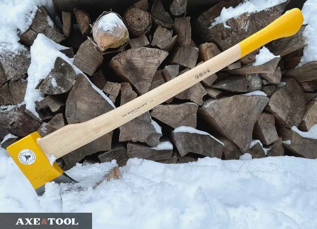 straight handled splitting axe in front of a pile of logs