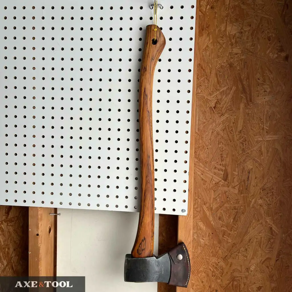 Axe being stored hanging on a wall with a lanyard