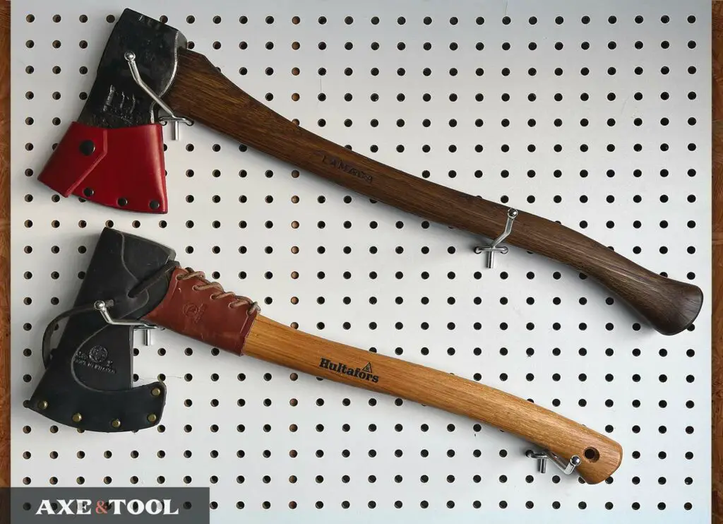 Two axes being displayed on a peg board wall