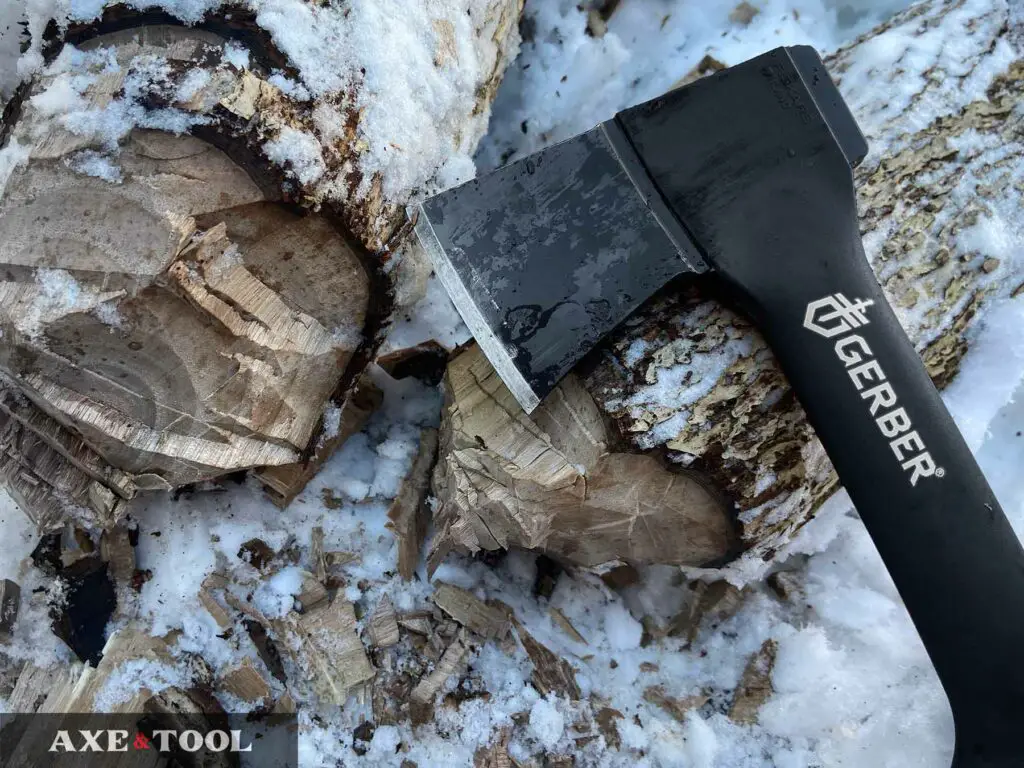 Gerber 9-inch hatchet with a chopped log in the snow