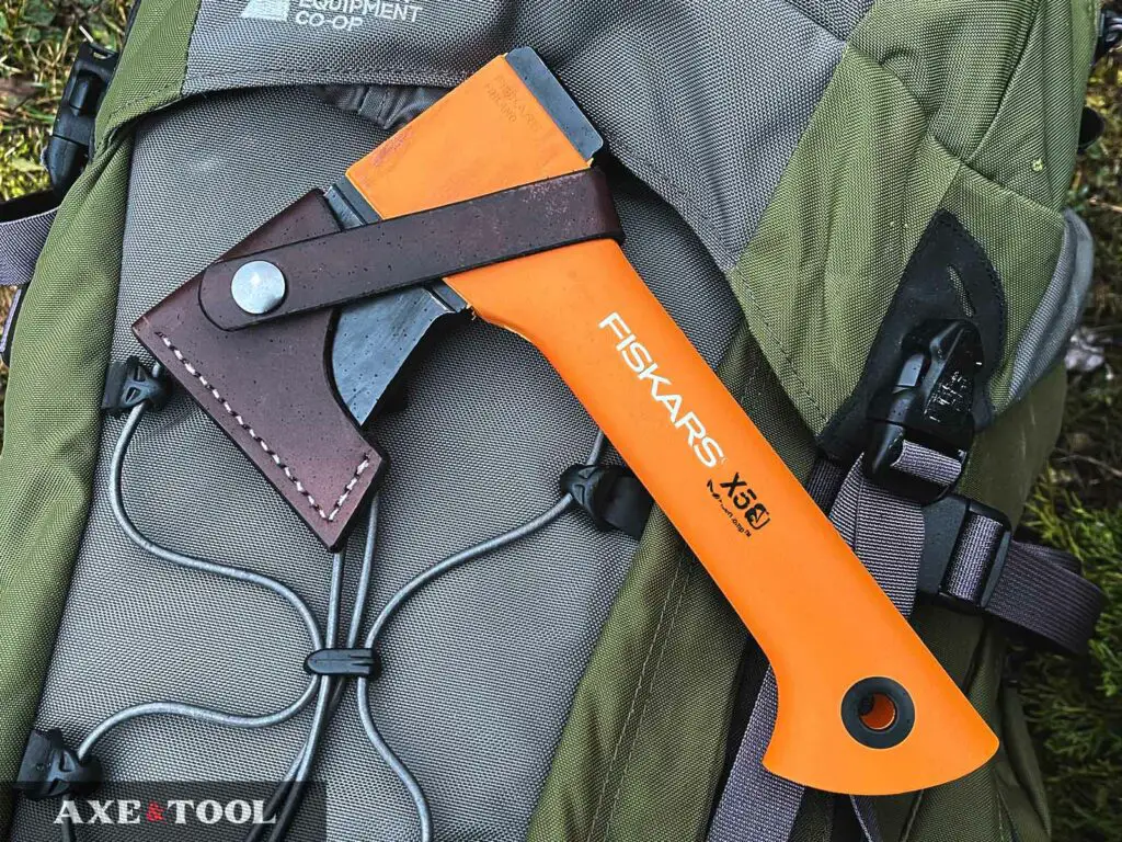 Fiskars X5 sitting on a hiking pack on the ground