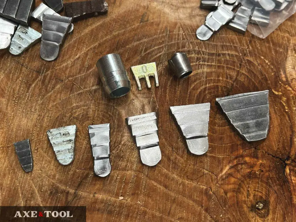 Assortment of metal step wedges and barrel wedges for tightening axe heads